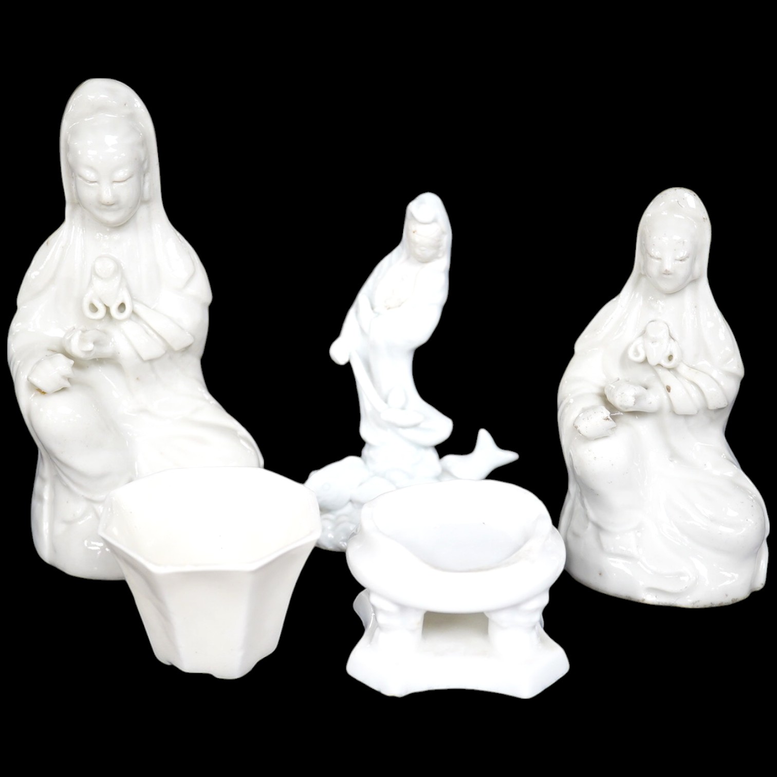 Three blanc de chine figures, one octagonal blanc de chine cup and a similar stand, largest 15cm high. Condition - good, stand is poor